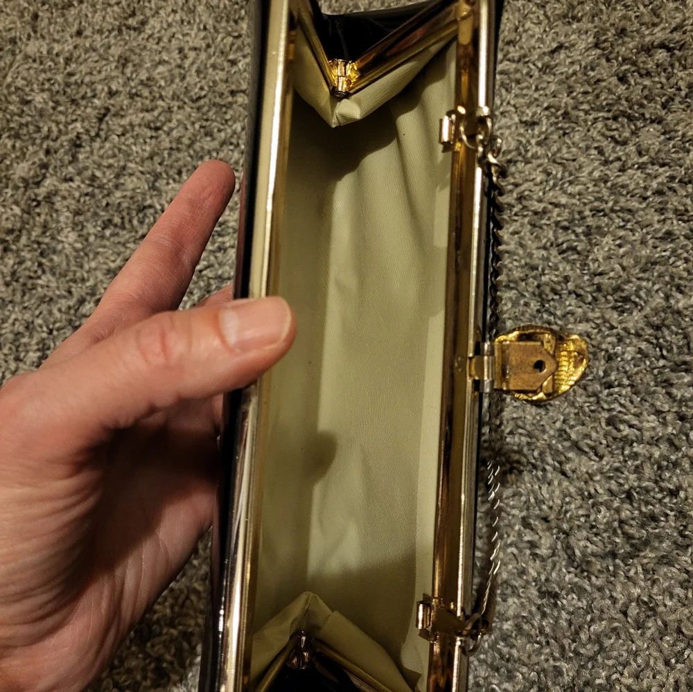 Elegant Black Clutch Bag with gold-tone hinged clasp and gold chain
